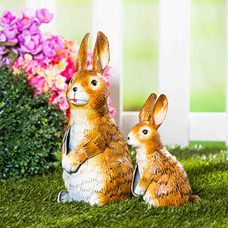 a pair of metal bunny garden sculptures