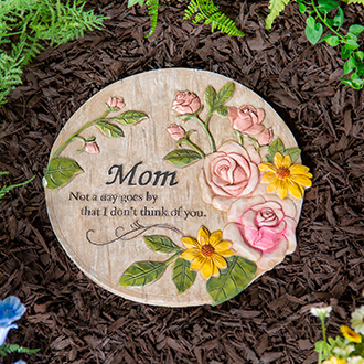 a plaque with flowers on it surrounded by leaves