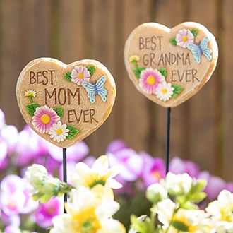 Two heart shaped best mom and grandma garden stakes with a floral design 