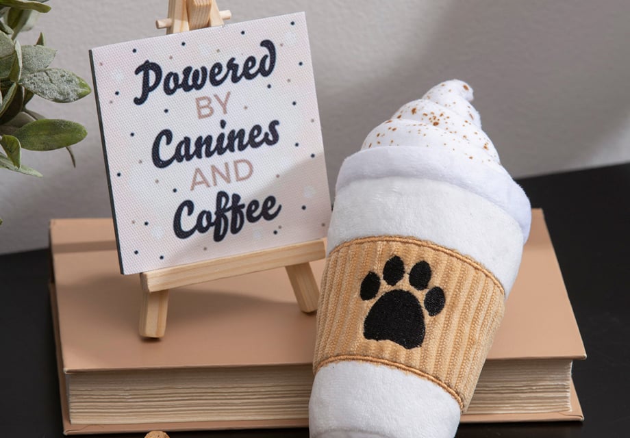 a stuffed coffee cup dog toy with a paw print on it